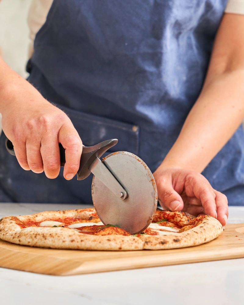 Ooni Profi-Pizzaschneider – mit passenden Accessoires arrangiert